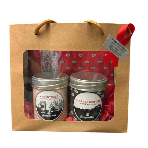 Gewurzladen Nafels Geschenktasche aus braunem Papier mit Sichtfenster und Dosen "MAGENTRAES" und "GLARNER GEWÜRZ".